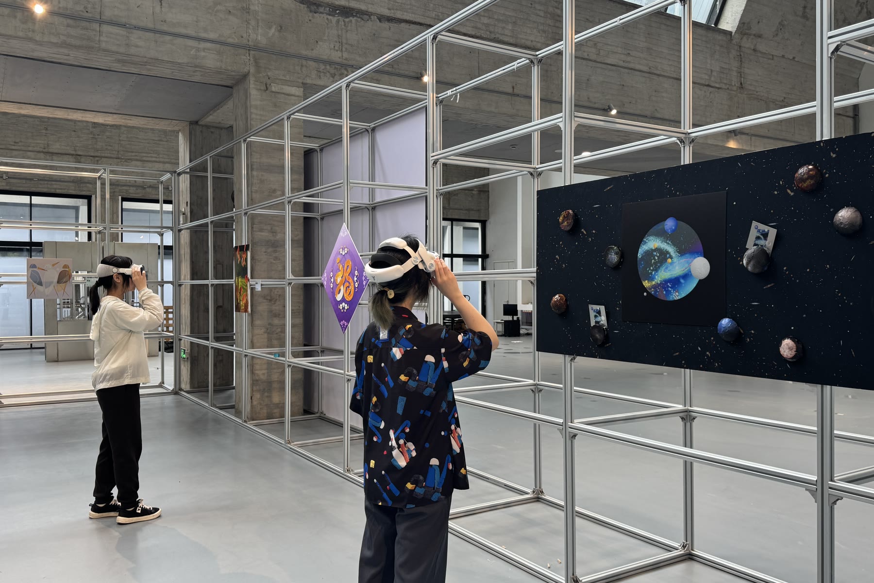 A student in a headset beside a spatial work, China Academy of Art